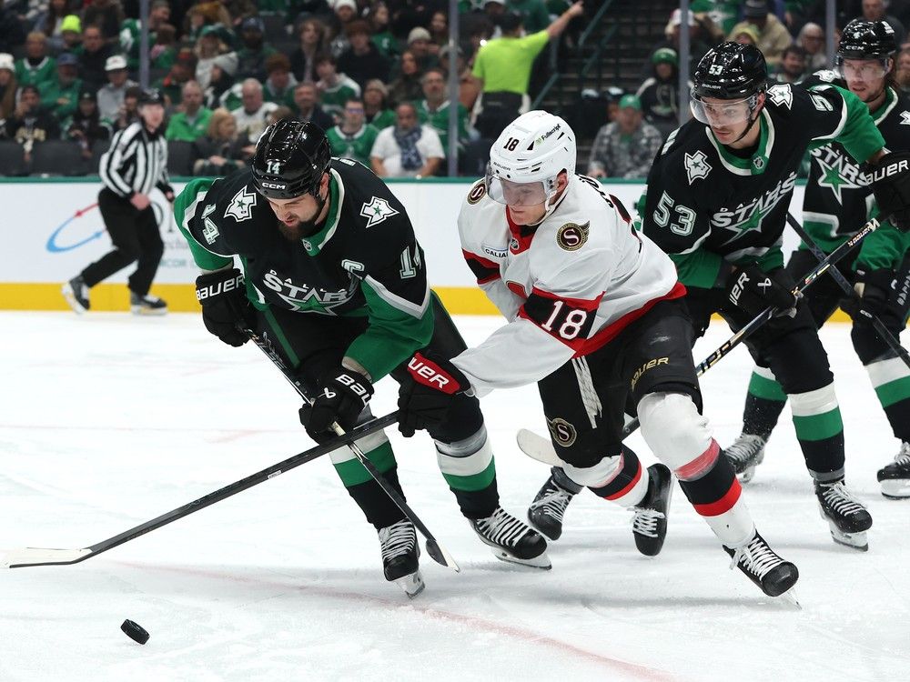  jamie benn of the dallas stars and tim stutzle of the ottawa senators compete for the puck during the second period at american airlines center on sunday, nov. 30, 2025 in dallas.