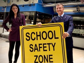 Beacon Hill-Cyrville Coun. Tim Tierney poses with one of the early concept school safety zone signs
