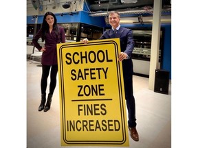 Tim Tierney poses with a school safety zone sign.