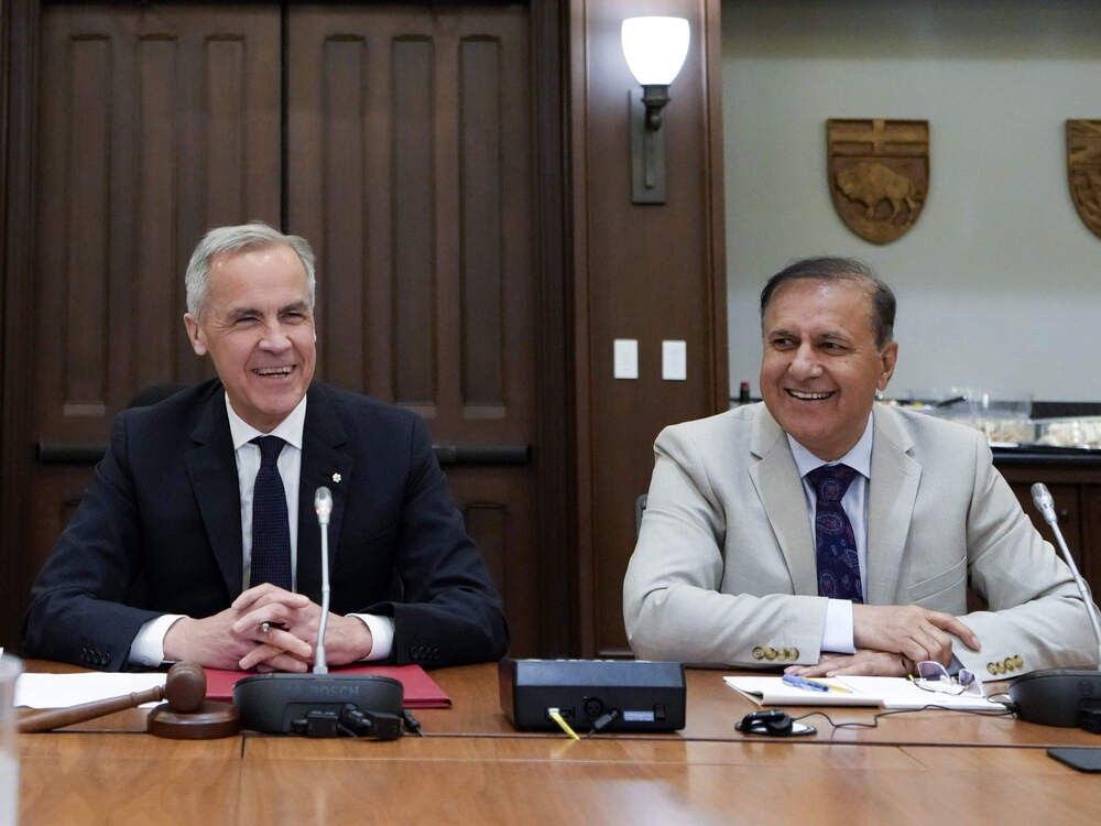 Treasury Board President Shafqat Ali right) has claimed he knows nothing about a rumoured full return to office. Justin Tang/THE CANADIAN PRESS