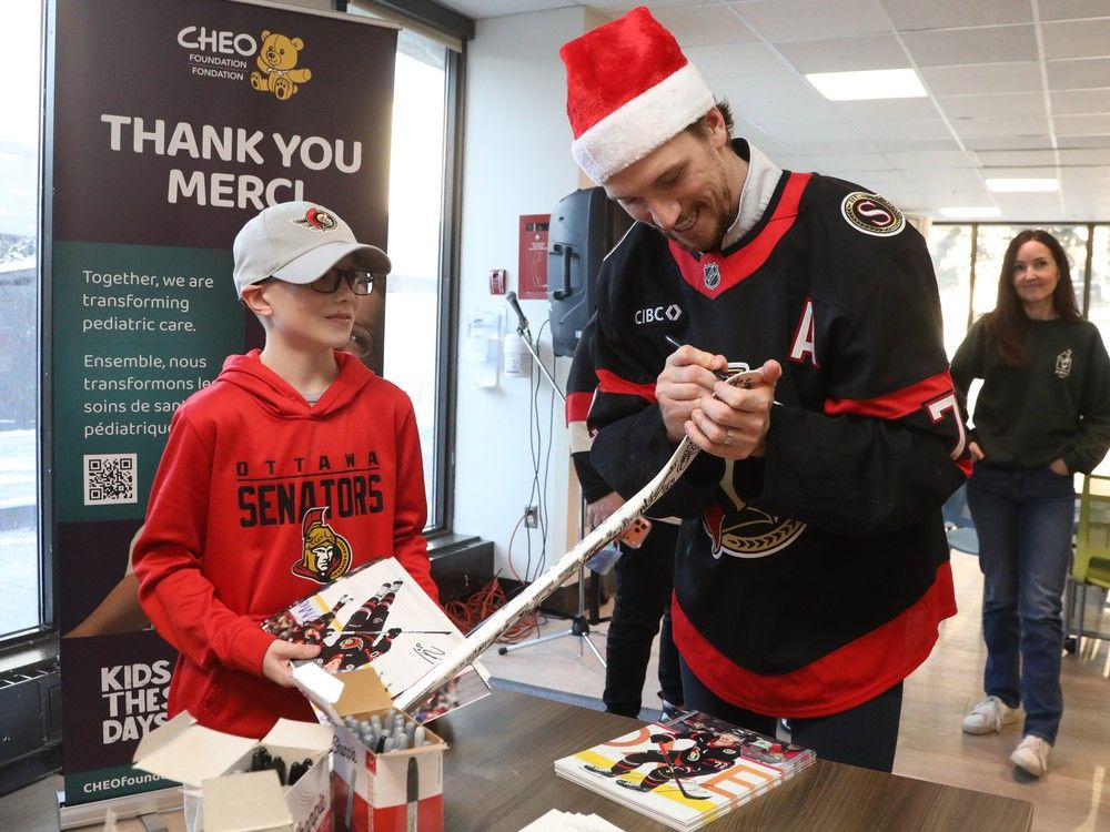 Thomas Chabot of the Ottawa Senators signs the stick of Parker McDonald, 11 years old. Thomas Chabot of the Ottawa Senators signs the stick of Parker McDonald, 11 years old.