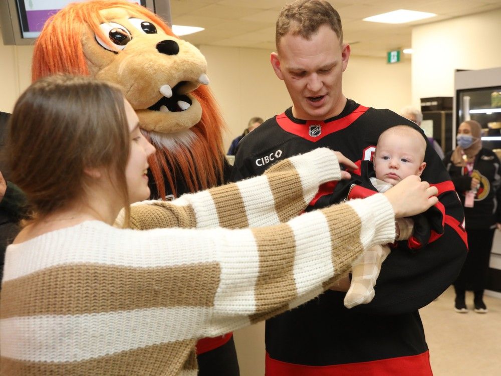Brady Tkachuk and Spartacat of the Ottawa Senators are photographed 2.5 months old Ollie Matteo Mallabone-Bérubé as mom Anna Mallabone fixes Ollie’s sense jersey for the photo. Brady Tkachuk and Spartacat of the Ottawa Senators are photographed 2.5 months old Ollie Matteo Mallabone-Bérubé as mom Anna Mallabone fixes Ollie’s sense jersey for the photo.