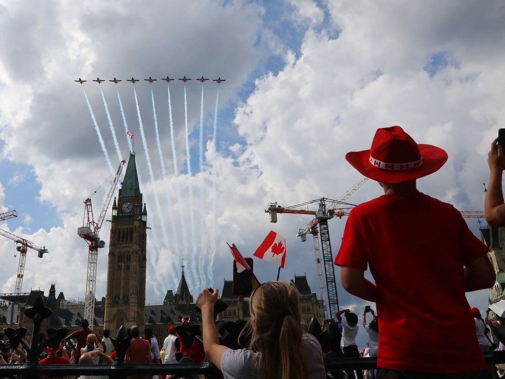 True Marut (girl on the left) and Layton Randall (right with cowboy hat) follow the Snowbirds as they fly past Parliament Hill and Ottawa during the Canada Day festivities in Ottawa. The celebration was well attended by many in the nation’s capital on July 1, 2025.