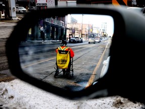 A man seeks money donations at the intersection of Rideau Street and King Edward Avenue in Ottawa, Feb. 11, 2025.
