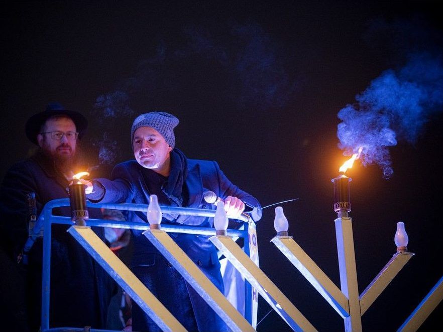  Rabbi Chaim Boyarsky joined by Harley Finkelstein, president of Shopify to light the Menorah at City Hall Sunday, Nov. 28, 2021.