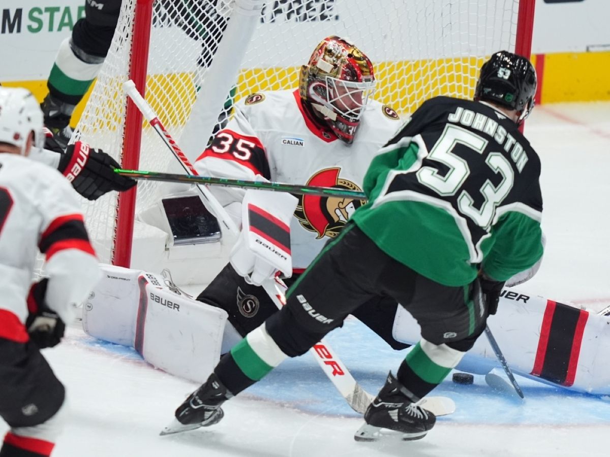 dallas stars centre wyatt johnston scores a goal against ottawa senators goaltender linus ullmark.