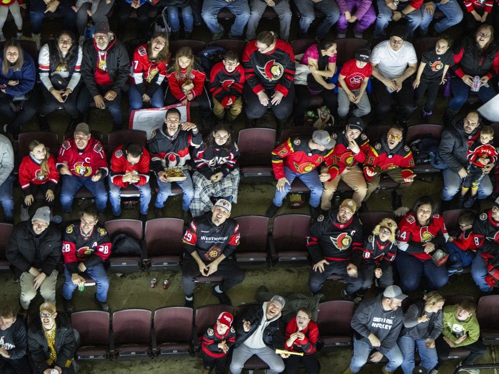  Fans look up, waiting for ‘Hot Dogs from Heaven’, during the Ottawa Senators’ game against the Chicago Blackhawks at the Canadian Tire Centre on Saturday, Dec. 20, 2025.