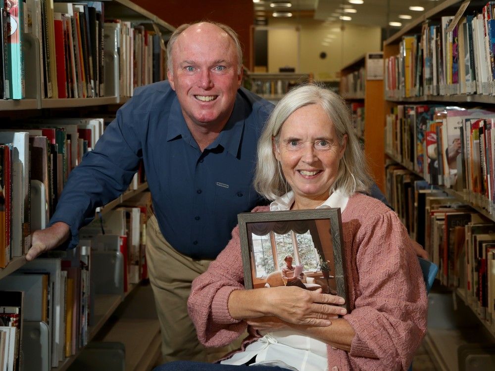  John Dodsworth and his wife, Jennifer Morin, hold a picture of his mom, Joan Dodsworth-Ware, who was Kanata&rsquo;s first librarian and a key community figure.