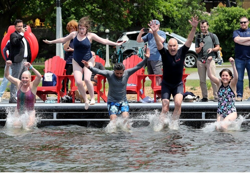JUNE 12, 2025 -- National Capital Commission CEO Tobi Nussbaum (second from right) was joined by local MP Yasir Naqvi (centre) and former MP Catherine McKenna (left) and others for a splashy opening of swimming season at the brand new Dow's Lake Dock.