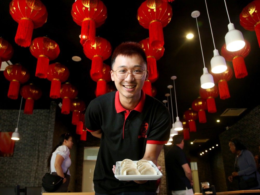 ULY 29, 2025 -- Doven Chan, co-owner of Dumpling Bliss, shows off some of the handmade, pre-cooked dumplings on offer in the restaurant.