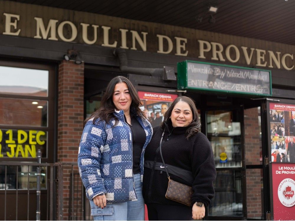  Emily Town (left) and Samantha Lupinacci (right) pose for a picture outside Le Moulin De Provence in Ottawa on Dec. 15, 2025. They had a bite of the limited edition Jonas Brothers cookies ahead of attending the concert  at the Canadian Tire Centre.