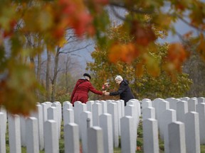 Nov 3, 2025 -- Jean Sibbald brings flowers with her daughter Barbara to her husband Major Ian Sibbald at The National Military Cemetery at Beechwood before Remembrance Day in Ottawa next week. Ian served with the Royal Canadian Air Force.