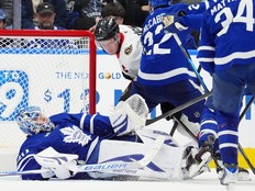 Ottawa Senators left wing Brady Tkachuk knocks Toronto Maple Leafs goaltender Joseph Woll to the ice as he handles the puck during the second period in Toronto on Saturday, Dec. 27, 2025.