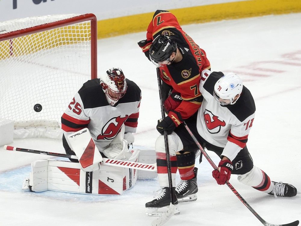 new jersey devils defenceman jonas siegenthaler ties up ottawa senators left-winger brady tkachuk as the puck deflects off goaltender jacob markstrom during the first period in ottawa on tuesday, dec. 9, 2025.