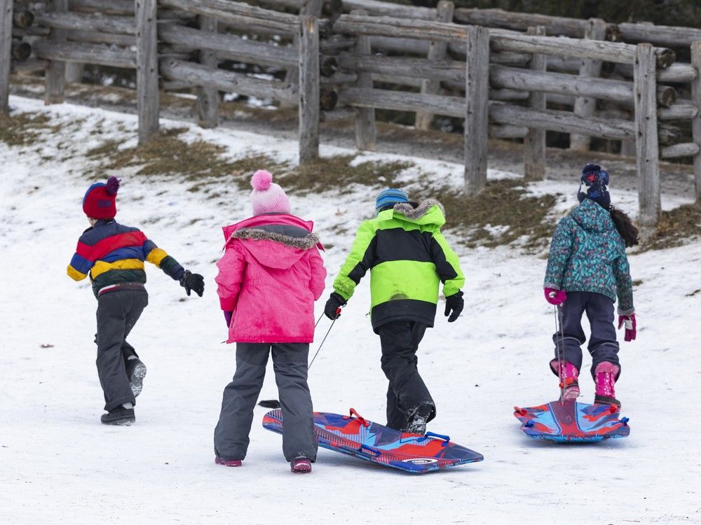 Kids make the trek back to the top of the toboggan hill at Walter Baker Park in Kanata in this file photo from Dec. 30, 2021. Kids make the trek back to the top of the toboggan hill at Walter Baker Park in Kanata in this file photo from Dec. 30, 2021.