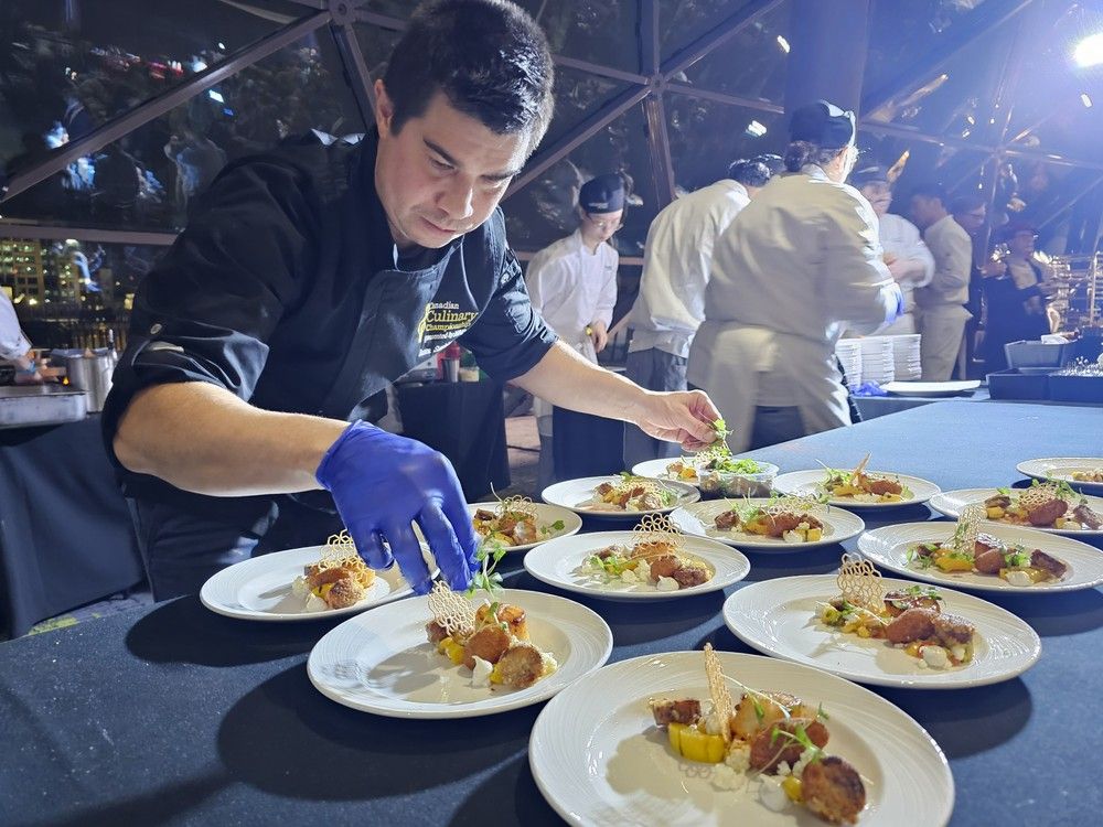  Ottawa Chef Jason Sawision of Stofa Restaurant adds topping to his dish of seared scallop with adobo, a taro Aji Amarillo fritter, almond pudding, mango salsa, &lsquo;chorizo&rsquo; shrimp toast, poblano pepper sauce and a tortilla tuile at the Canadian Culinary Championships 2026.