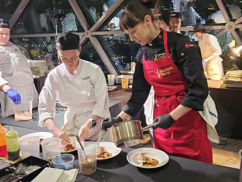  Chef Emily Butcher of Nola in Winnipeg pours Massaman curry sauce on smoked duck and squash dumplings, black pepper-glazed octopus, fermented kohlrabi slaw, toasted peanut and puffed wild rice at the Canadian Culinary Championship 2026.