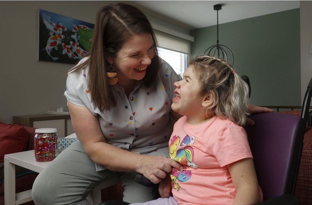  Julie Jewett and her daughter Lily share a laugh. Jewett’s request to have Lily’s medication covered by Canada Life was refused.