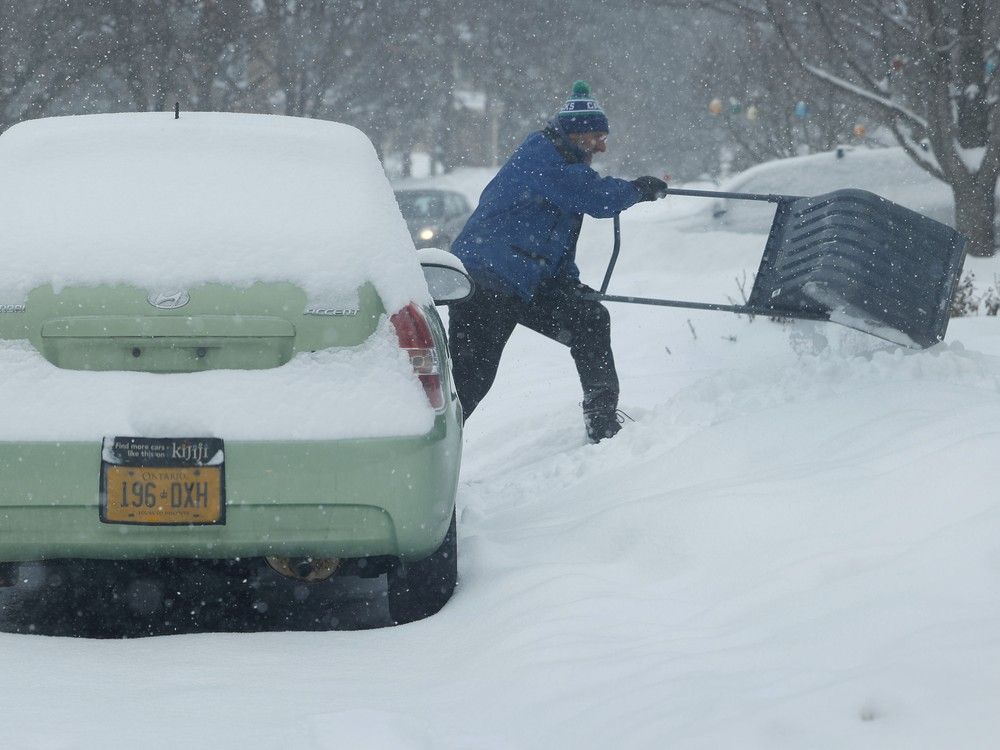  A man shovels snow during a winter snow storm in Ottawa Thursday afternoon.