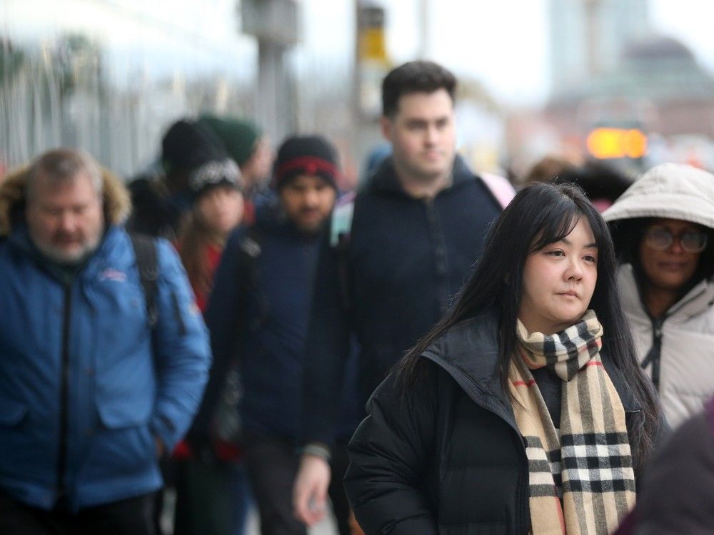 People coming and going from the Tunney's Pasture LRT