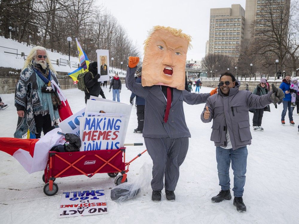 Puppet artist Velvet LeClair, dressed as Donald Trump, walked along the Rideau Canal alongside anti-ICE activists, drawing crowds who stopped for selfies. A banner reading “ICE is for skating, not kidnapping” hung from the Corktown Footbridge on Sunday, Feb. 15, 2026. Puppet artist Velvet LeClair, dressed as Donald Trump, walked along the Rideau Canal alongside anti-ICE activists, drawing crowds who stopped for selfies. A banner reading “ICE is for skating, not kidnapping” hung from the Corktown Footbridge on Sunday, Feb. 15, 2026.