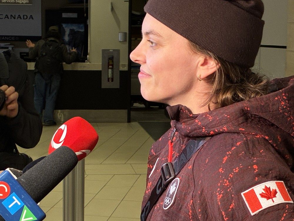  Emily Clark, Team Canada women&rsquo;s hockey silver-medallist, speaks with media at the Ottawa/Macdonald&ndash;Cartier International Airport on Monday night after returning from the Milano-Cortina Winter Olympics.