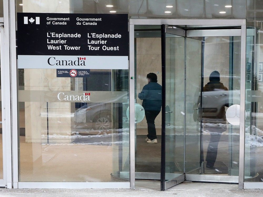 A Liberal MP has broken ranks to oppose the mandate as unions gear up for a legal fight and public servants brace for longer commutes.