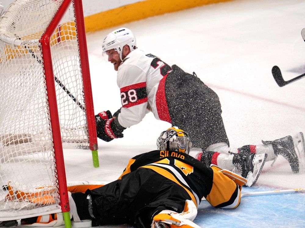 Claude Giroux slides into the goal post after scoring against Pittsburgh Penguins