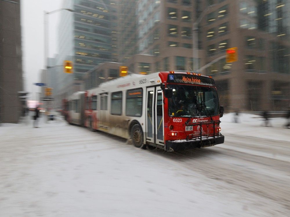 OC Transpo bus driving in the snow in downtown Ottawa