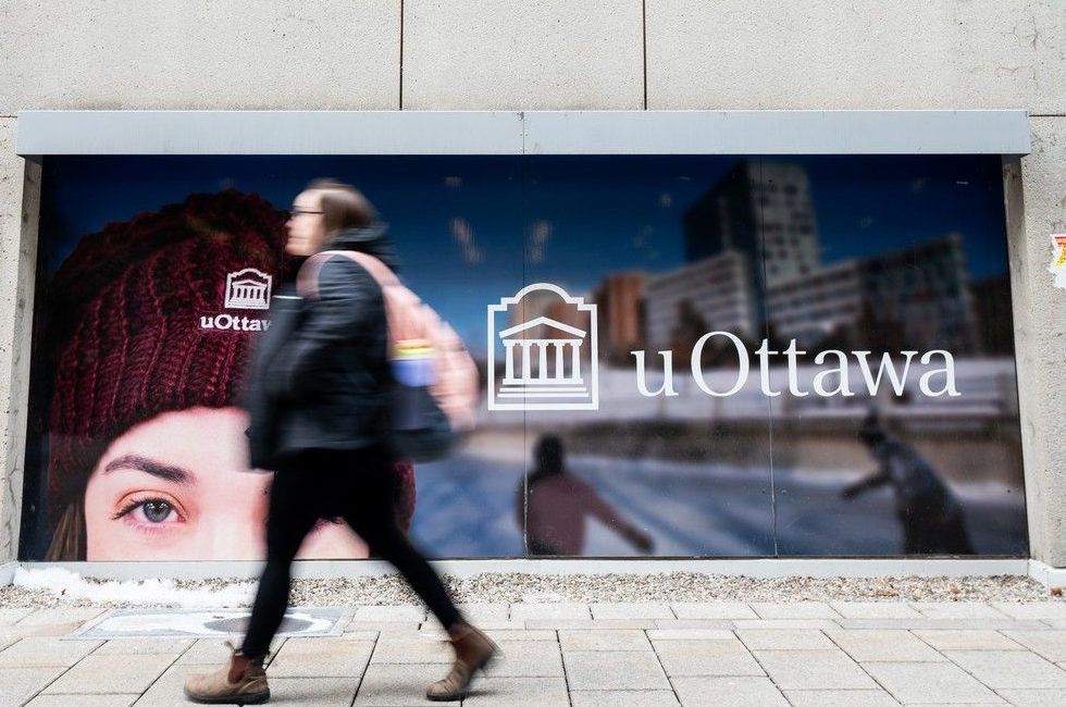 A person walks past a University of Ottawa sign on Jan. 30, 2024. A person walks past a University of Ottawa sign on Jan. 30, 2024.