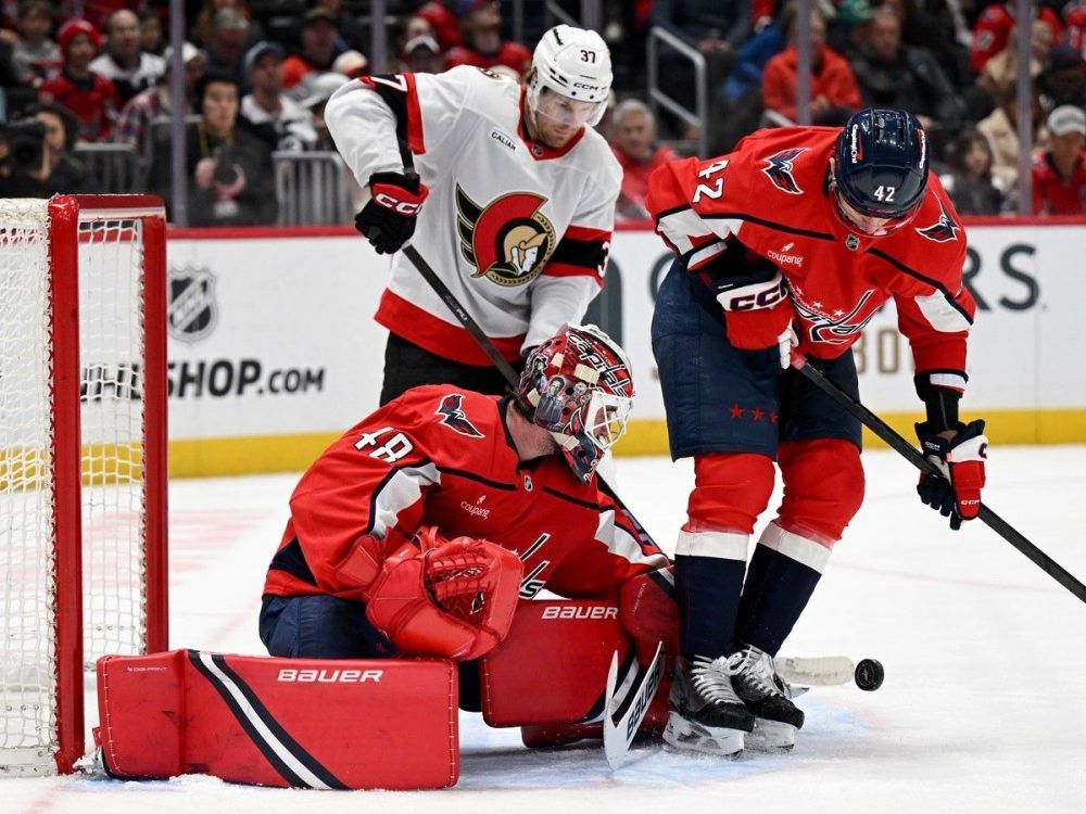  Logan Thompson of the Washington Capitals makes a save in the first period as Warren Foegele of the Ottawa Senators looks for the rebound at Capital One Arena on March 18, 2026 in Washington.