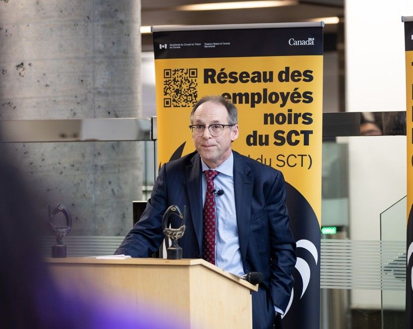 Bill Matthews behind a dais at an event.