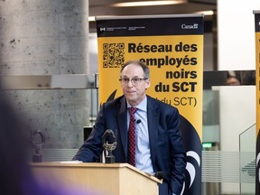 Bill Matthews behind a dais at an event.