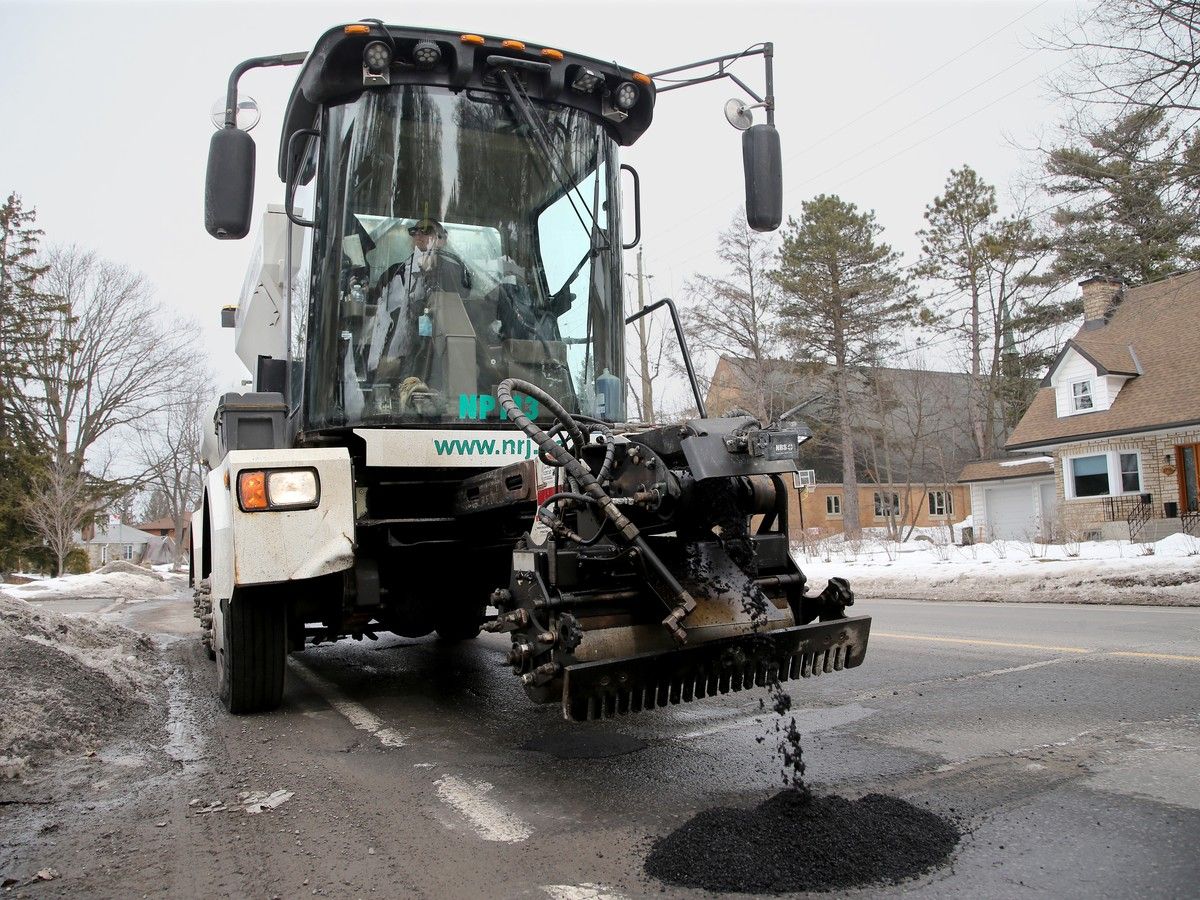 Caroline Bissonnette works the pothole patching machine, the Python 5000, on Alta Vista Drive Tuesday.