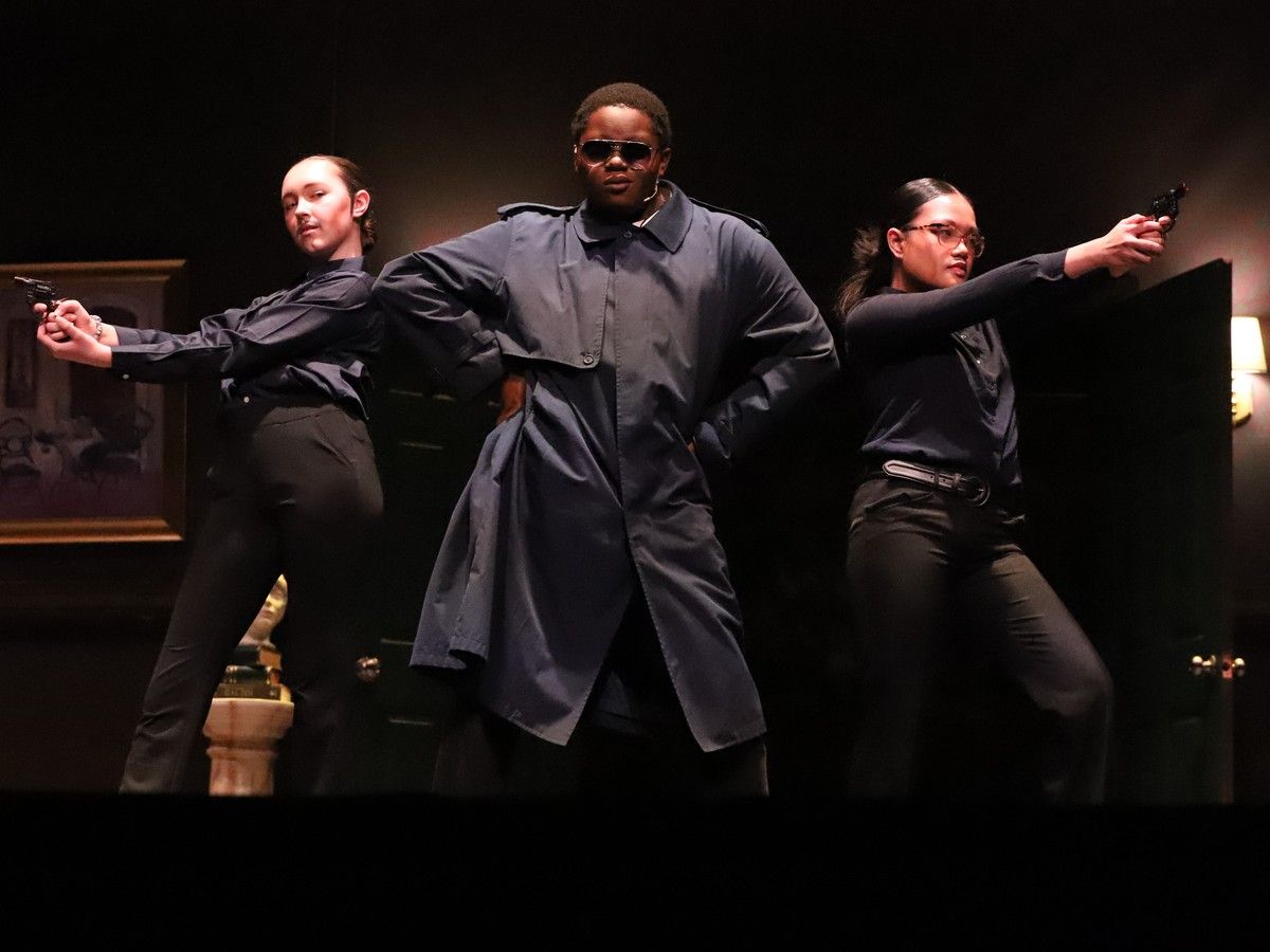 Police Officer played by Rebecca Shaver (L), Chief of Police played by Nosaze Osaze (M), and Police Officer played by Monalisa Maclang (R) during Saint Joseph Catholic High School's Cappies production of CLUE.