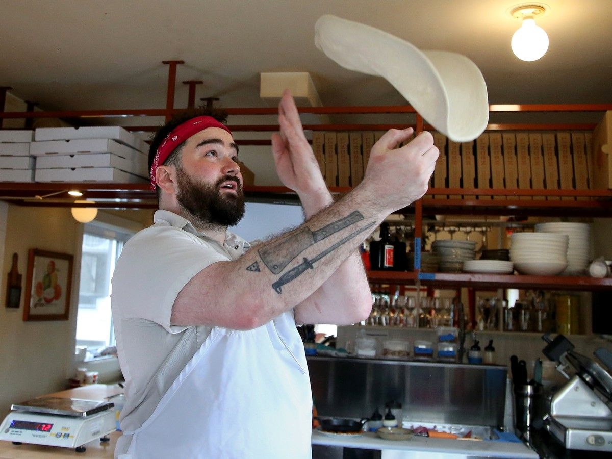  Chef Coombes prepares a Valentina pizza in the kitchen at Linden Pizza on Beechwood Avenue.