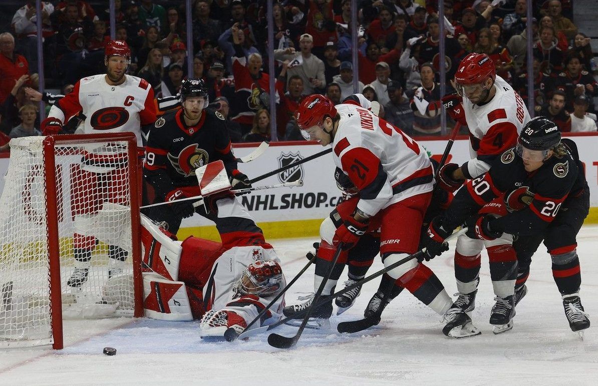 The Ottawa Senators try to get the puck past Carolina Hurricanes goalie Frederik Andersen