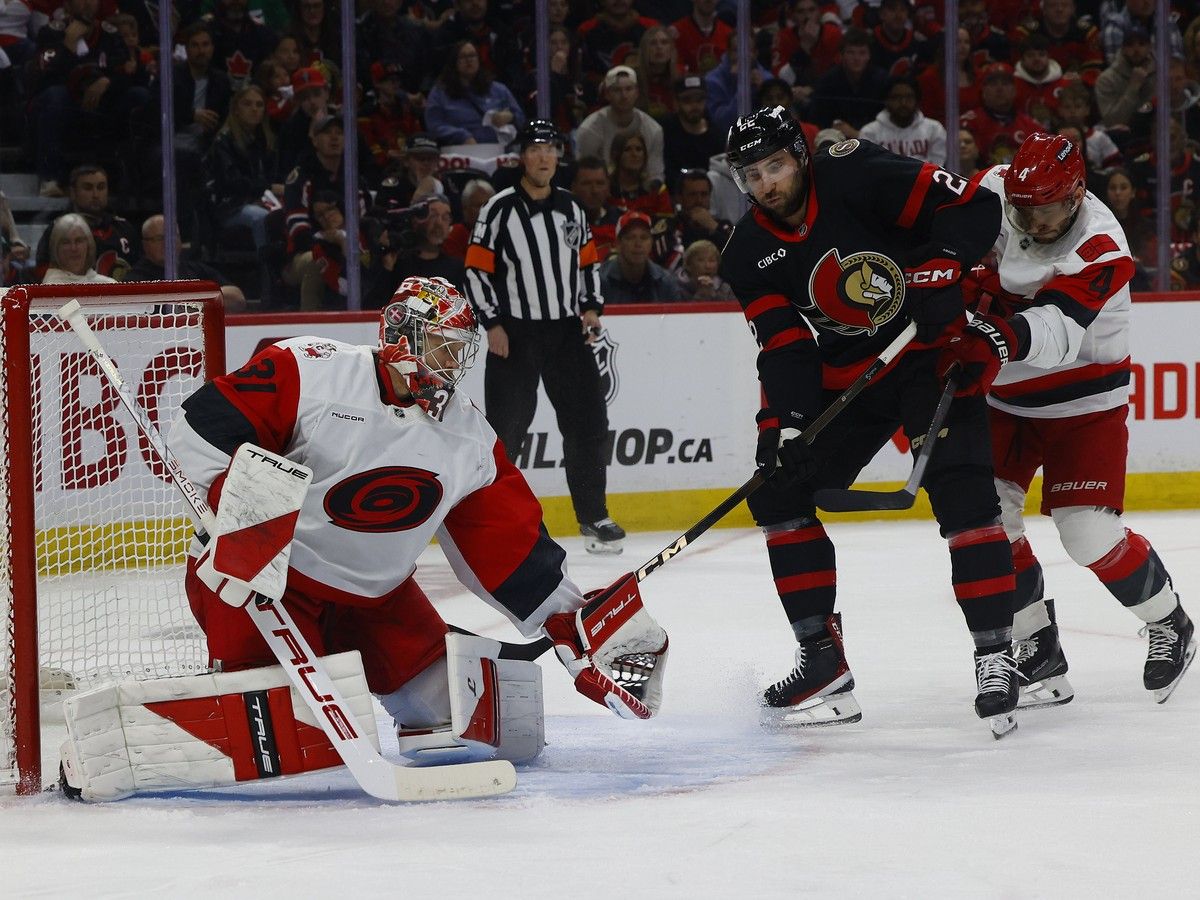 Ottawa Senator Michael Amadio looks for a rebound as Carolina Hurricanes goalie Frederik Andersen makes a save