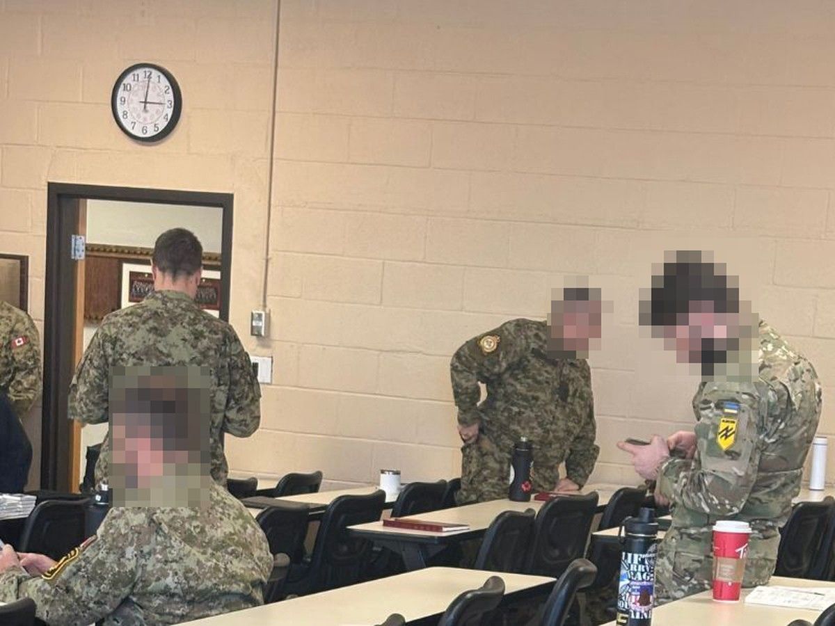  A member of the Azov Brigade (far right) takes a break during Canadian military leadership training at the Royal Military College Saint-Jean in Quebec.
