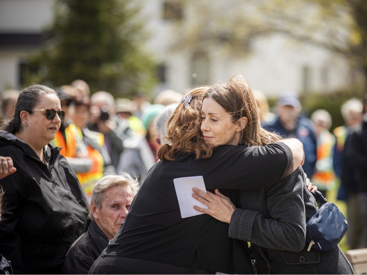 Mary Honeywell Elementary School vice-principal Lisa Baker gave Amanda Clark, widow of Barrhaven crossing guard Peter Clark, a hug