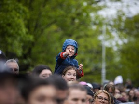 A young fan was cheering and watching for their runner to come down the route Sunday morning.