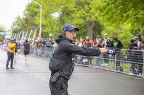 Ian Fraser was helping direct runners to the finish line Sunday morning.