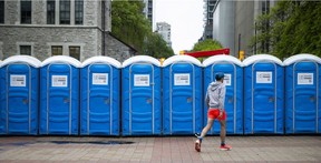 A lone runner makes his way to the porta potties before the start of the marathon Sunday.