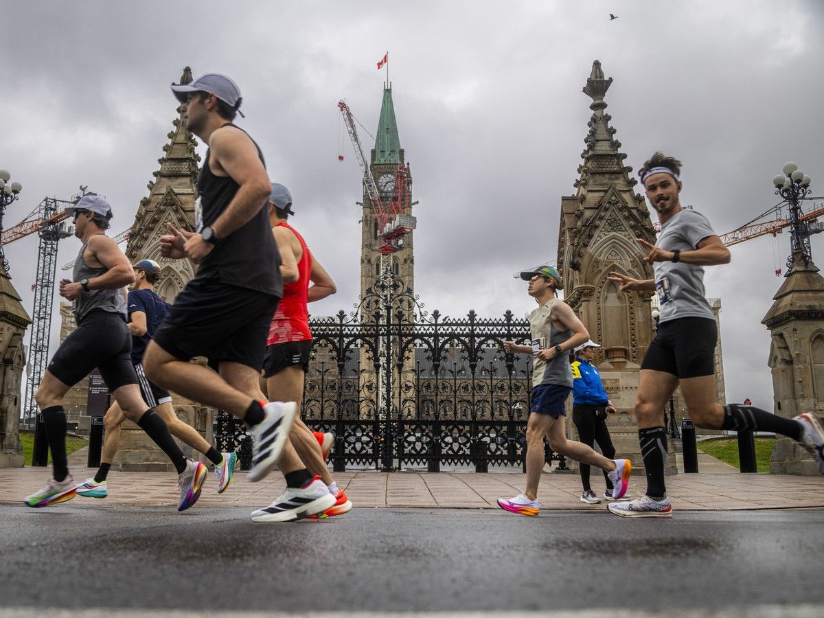  Marathon runners make their way past Parliament Hill during the first couple kilometres of their race.