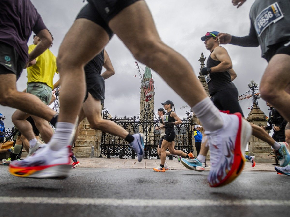  Marathon runners make their way past Parliament Hill during the first couple kilometres of their race.