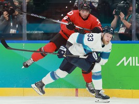 Nikolas Matinpalo of Team Finland and Nick Suzuki of Team Canada collide