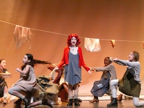 Annika Oosterman performs as an orphan (FL), Maya Dahmani performs as Molly (L), Maya Gervais performs as Annie, Tofunmi Yusuf performs as an orphan (R), Kaitlyn Hennessey performs as Duffy (FR), in St. Mother Teresa's production of Annie
