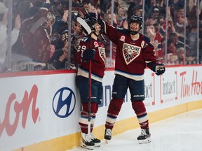 Montreal Victoire forward Marie-Philip Poulin, left, and Laura Stacey celebrate