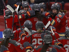 Michela Cava from the Ottawa Charge celebrates her double-overtime winning goal with her teammates on Sunday at the Canadian Tire Centre. Ottawa defeated Boston 4-3 in Game 4 to take the semifinal series 3-1.
