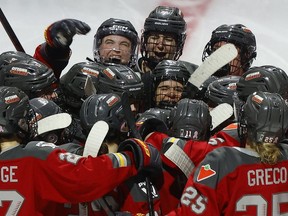 Michela Cava of the Ottawa Charge celebrates her double-overtime winning goal with her teammates on Sunday